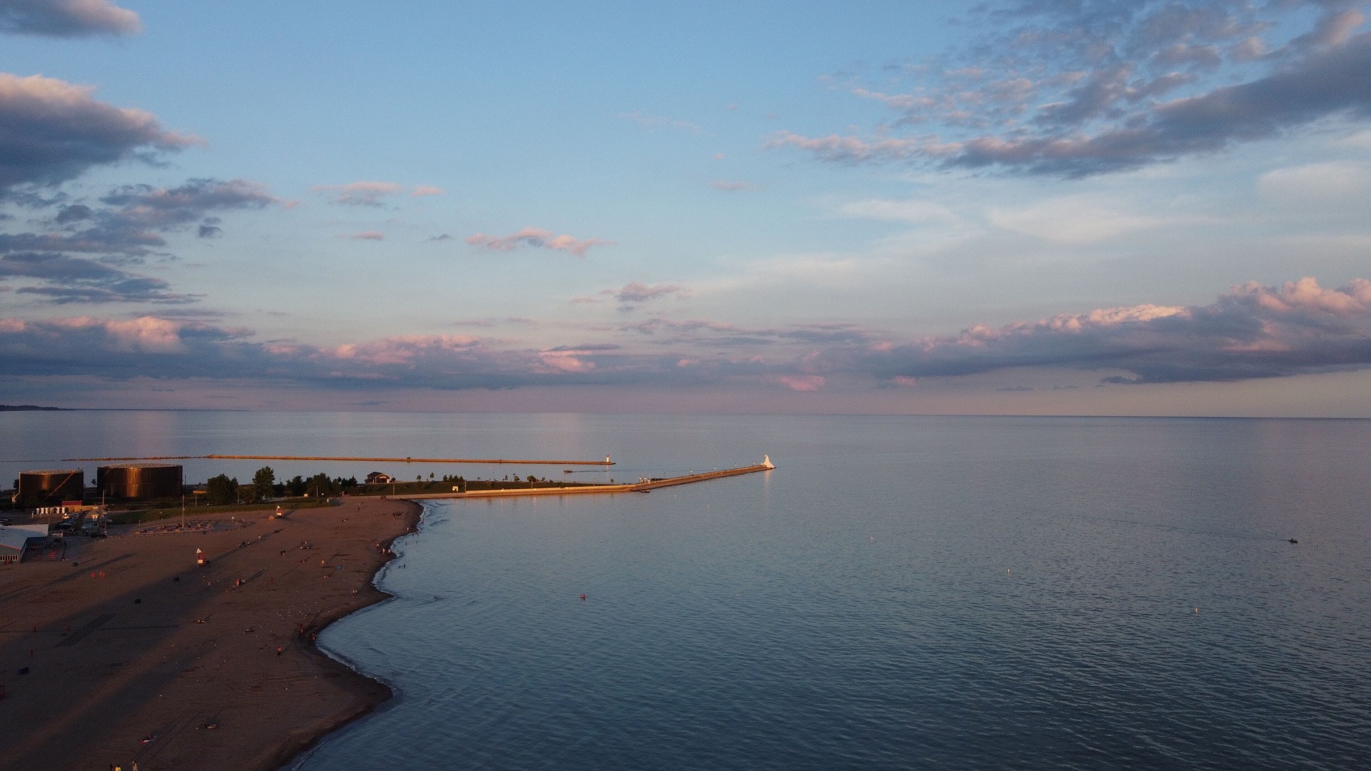 Aerial view of the Port Stanley pier and beach on Lake Erie at sunset